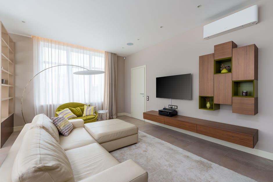 Interior of living room with stylish furniture and large comfortable sofa in luxury apartment in daylight