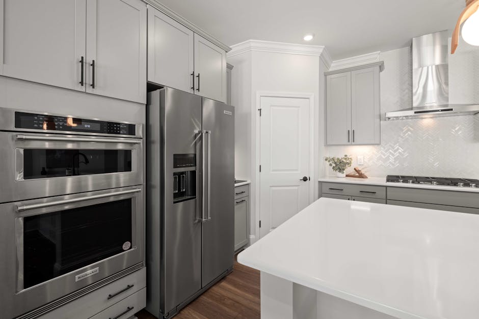 Contemporary kitchen featuring sleek stainless steel appliances and minimalist design.